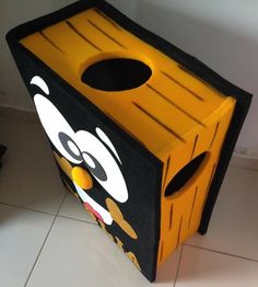 a yellow and black trash can sitting on the floor