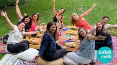 a group of women sitting around a picnic table