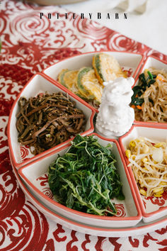 a plate filled with different types of food on top of a red and white table cloth