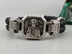 "Orthodox bracelet \" Sergius of Radonezh \" Materials: - Sterling Silver 925 K. Weight - 84 +- g. - Genuine leather. Bracelet width - 26 mm Also, you can order any size what you need on request. We need 2 weeks to make a bracelet with various changes such as: -other bracelet's size -other jewelry stones Please check all my catalog to choose your favorite brutal jewelry, skull bracelet, skull ring, skull pendant https://www.etsy.com/shop/YetiBikersJewelry All of our jewelry have been designed an Silver Leather Bracelet With Sterling Clasp As Gift, Leather Bracelet With Sterling Silver Clasp For Gift, Silver Leather Jubilee Bracelet As Gift, Luxury Handmade Sterling Silver Bracelet, Handmade Luxury Sterling Silver Bracelet, Spiritual Silver Leather Bracelet As Gift, Silver Engraved Leather Bracelet As Gift, Silver Engraved Leather Bracelet Gift, Engraved Silver Leather Bracelet As Gift