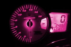 the speedometer is lit up with pink light