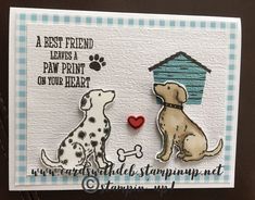 a card with two dogs and a doghouse on the front, one is holding a heart