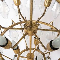 an antique chandelier with many glass bottles hanging from it