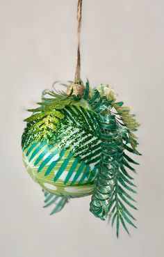 a green ornament hanging from a rope