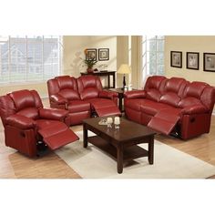 a living room filled with red leather furniture