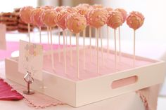 there are many cake pops on the table