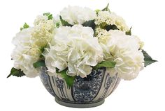 white flowers in a blue and white vase