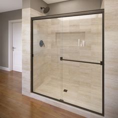 a bathroom with a glass shower door and wood flooring on the side of the room