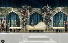 the stage is decorated with flowers and gold furniture