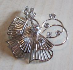 "T K sterling silver and rhinestone pin. 1 11/16\" wide x 1 1/2\" tall. The two loops are the top of the pin. 8 round stones of various sizes and 5 baguettes. Good condition. Shipped by US first class mail PIN-3" Tucson Az, Silver Rhinestone, Tucson, Brooches, Two By Two, Sterling Silver, Stone, Silver