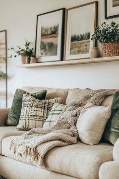 a living room filled with lots of furniture and pictures on the wall above it's couch