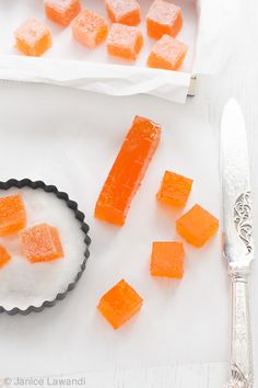 several pieces of orange and white candy on a plate