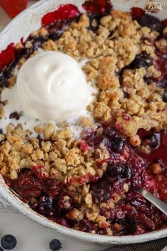 a close up of a bowl of food with fruit and ice cream on top,