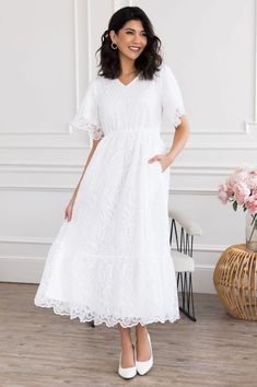 The Nadene Elegant Flowy V-neck Lace Dress, Flowy Feminine Lace Dress, Feminine V-neck Delicate Lace Dress, Feminine Short Sleeve Lace Dress With Ruffles, Flowy Scalloped Lace Dress, Feminine Short Sleeve Dress With Delicate Lace, Feminine Short Sleeve Delicate Lace Dresses, Flowy V-neck Lace Dress For Spring, Lace Dress With Flutter Sleeves