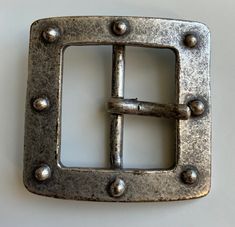 This is a beautiful square centre bar belt buckle. The design features a distressed antique nickel plating with round studs. A great twist on a classic style. I would say the style could be anywhere from gothic to boho. Very versatile buckle. Designed to be worn with an 1.5' (38mm) belt strap. Gothic Antique, Buckles Fashion, Nickel Plating, Suspender Belt, Suspenders, Belt Buckle, Belt Buckles, Classic Style, Buckle