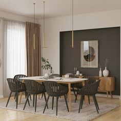 a dining room table and chairs in front of a window