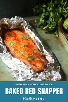 baked red snapper fish with spicy honey lime sauce in foil on a cutting board