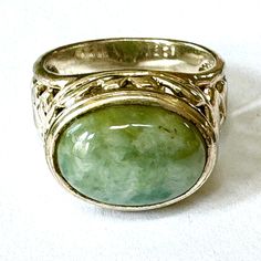 Sterling Jade Ring, High Setting, Oval Jade Stone, Ornate Sterling Filigree Sides, Size 8 Ring, Vintage Gemstone Jewelry Vintage sterling silver jade ring ring with ornate filigree design.  Large oval jade stone with ornate open work high setting with filigree sides. The ring is signed 925 SU Thailand.  Size 8   The top of the ring is 3/4"  x 1/2" x 3/8" high..    Wonderful vintage condition. More Jade https://www.etsy.com/shop/VintageVogueTreasure?ref=hdr&search_query=jade More rings https://www.etsy.com/your/shops/VintageVogueTreasure/tools/listings/query:ring,order:ascending Brass Plate, Saint James, Jade Ring, Filigree Design, Jade Stone, Classic Ring, Ring Vintage, Jewelry Vintage, Ring Ring