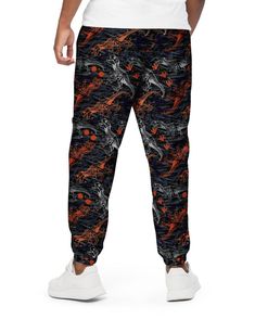 Meet your new favorite pants: One Stop Rave's T-Wrecked Unisex Track Pants! Whether you're working out, attending Lost Lands Festival, or just hanging out, these pants got you covered. Sporting our unique dinosaur print, these track pants are made from 100% polyester, making them lightweight and water-resistant. The fully lined mesh interior, along with elastic waistband and ankle cuffs, ensure comfort and a relaxed fit. With zip pockets and a hip-sitting design, these pants combine style with p Casual Printed Loungewear Pants, Casual Loungewear Printed Pants, Stretch Casual Pants With All Over Print, Casual Stretch Pants With All Over Print, Stretch Black Bottoms With All Over Print, Casual Printed Bottoms For Streetwear, Casual Relaxed Fit Pants With All Over Print, Casual Streetwear Bottoms With All Over Print, Casual All Over Print Bottoms For Streetwear