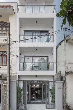 an apartment building with balconies on the second floor