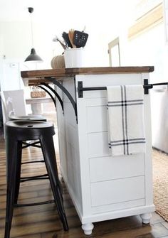 a kitchen island with two stools next to it