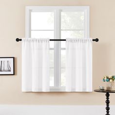 a window with white curtains in front of it