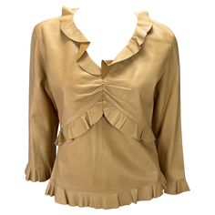 Presenting a saddle-colored leather ruffled Gucci top, designed by Tom Ford. From the Spring/Summer 1999 collection, fabric versions of this top debuted on the season's runway. This incredible top is constructed entirely of soft lightweight leather in saddle color. The shirt features cropped sleeves, a v-neckline, and ruching at the bust. Made complete with ruffle details at the neckline, waist, hem, and cuffs this late 1990s top is the perfect addition to any Tom Ford Gucci lover's wardrobe. Ap Gucci By Tom Ford, Tom Ford Gucci, Gucci Top, Saddle Brown, V Neck Blouse, Tom Ford, Saddle, Spring Summer, Ford