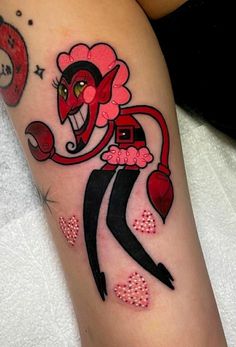 a woman's leg with an evil clown tattoo on her left thigh and hearts around her ankles