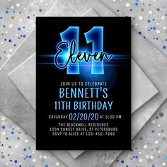 a birthday party card with the number eleven in blue and silver on it, surrounded by confetti