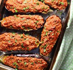 baked stuffed eggplant in a baking pan with parsley on the top, ready to be eaten