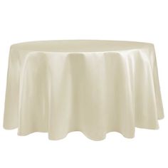 a white table cloth on top of a round tablecloth with ruffled trims