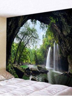 a bed room with a wall hanging tapestry and a waterfall in the forest behind it