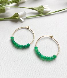 Emerald Hoop Earrings. Ten faceted emeralds adorn each hoop for a total of 20 emeralds in these beautiful earrings! These are perfect with jeans and a t-shirt or to wear with your best outfit! The hoops measure 1-1/4 inches in length and width or just over 3 cm. These earrings are available in either gold plated or rhodium plated finish. Emerald is the May birthstone. Your emerald hoop earrings will arrive gift boxed. If this is a gift, I would be glad to include a card with your personal messag Elegant Hoop Earrings With Faceted Beads, May Birthstone Round Hoop Earrings, May Birthstone Round Hoop Earrings For Pierced Ears, Faceted Hoop Earrings As Gift, Small Hoop Earrings With Faceted Beads For Gift, Small Hoop Jewelry With Faceted Beads For Gifts, Faceted Beads Dangle Hoop Earrings For Gifts, Hoop Jewelry With Faceted Beads For Gifts, Gift Hoop Earrings With Faceted Beads