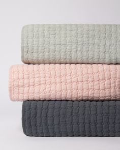 three blankets stacked on top of each other