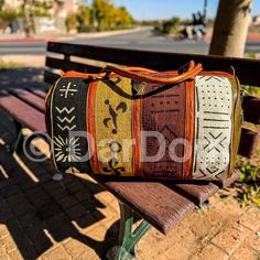 a purse sitting on top of a wooden bench