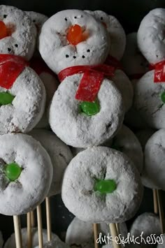 there are many donuts with snowmen on them that have green and red candies