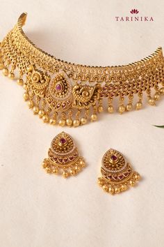 tarinika temple classic antique choker set Intricate Design Choker For Reception And Festivals, Intricate Design Choker For Receptions And Festivals, Elegant Gold Sets With Peacock Design, Elegant Gold Set With Peacock Design, Gold Sets With Peacock Design For Festive Season, Traditional Temple Necklace With Intricate Design For Reception, Festive Gold Sets With Peacock Design, Festive Intricate Temple Choker Necklace, Temple Jewelry Sets With Intricate Design For Reception