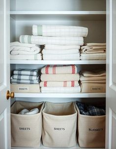 an organized closet with linens and towels