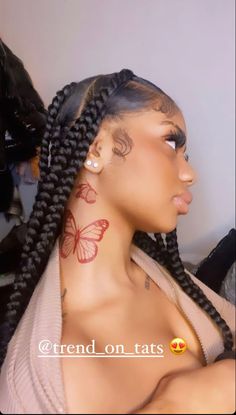 a woman with butterfly tattoos on her neck and shoulder, looking off to the side