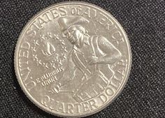 a silver coin with an image of a man on it