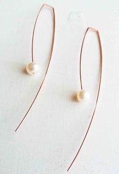 Long delicate arc shape threader earring made of 14k rose gold filled wire and floating 6mm white fresh water pearl. Earrings pictured measures 3 inches long from point of entry in ear. Pearl dangles 1 3/4 inches from point of entry of ear. Back sweep measures 1 1/4 inch from bottom of pearl. Also Available in 14K yellow gold filled, 14K rose gold filled, and sterling silver. Shorter lengths are also available. bluewavejewelry.etsy.com Crisscross hoops: https://www.etsy.com/listing/234139174/cri Elegant Wire Wrapped Threader Earrings, Rose Gold Teardrop Pearl Earrings With Ear Wire, Elegant Adjustable Rose Gold Hoop Earrings, Delicate Long Drop Rose Gold Earrings, Minimalist Rose Gold Dangle Pearl Earrings, Minimalist Rose Gold Teardrop Pearl Earrings, Minimalist Rose Gold Pearl Earrings, Elegant Adjustable Wire Wrapped Hoop Earrings, Elegant Wire Wrapped Threader Earrings For Gifts