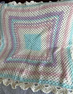 a crocheted blanket on top of a bed