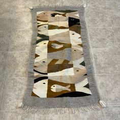 the rug is on the floor and it has many different colors, shapes and sizes