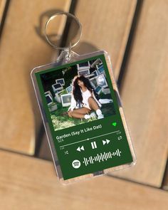 a keychain hanging from a wooden bench with an mp3 player attached to it