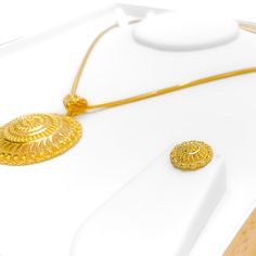 This Fascinating Feather Accented 22k Gold Pendant Set, with a gold weight of 16.7 grams, merges nature-inspired beauty with luxurious design. The set is crafted in 22k gold, featuring a yellow gold finish that beautifully highlights the feather accents. The pendant is 2 inches in length, adding a touch of elegance. Matching earrings, each 0.6 inches long, come with screw-back posts for secure wear. This 3-piece set, not including a chain, is perfect for those who adore the combination of organi Yellow Gold Filigree Jewelry Sets As Gift, Yellow Gold Filigree Jewelry Sets For Gift, Yellow Gold Plated Filigree Jewelry Sets, Yellow Gold Filigree Gold-plated Jewelry Sets, Traditional Oval Yellow Gold Necklaces, Traditional Polished Yellow Gold Jewelry, Traditional Yellow Gold Jewelry With Polished Finish, Traditional Oval Yellow Gold Necklace, Traditional Yellow Gold Oval Necklace