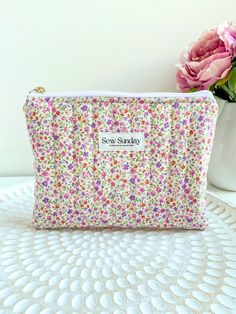 Our large quilted makeup pouch is handmade using cotton fabric. It offers function and style and fits perfectly in your handbag while you're on the go. We recommend using it for cosmetics, skincare, haircare, stationary and other accessories.  Featuring a floral design, stunning gold zipper pull and a beige lining. Perfect for travel and everyday use. Dimensions of product  21cm width x 16cm height Care instructions Hand wash recommended or machine cold wash on gentle cycle in wash bag Everyday Quilted Pouch Cosmetic Bag, Quilted Cosmetic Pouch Bag As Gift, Quilted Pouch Cosmetic Bag, Quilted Pouch Cosmetic Bag Gift, Quilted Pouch Cosmetic Bag As Gift, Quilted Pouch Bag For Gift, Quilted Pouch Bag As Gift, Gold Zipper, Makeup Pouch