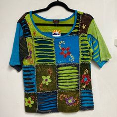 New! Rising International Colorful Boho Top. Large & Xxl Available! 100% Cotton Colorful With Embroidered Flowers, Thick Stitching. Thick Material And Stretchy. Measures: Large: Shoulder Hem To Bottom 24 1/2 Inches Armpit To Armpit: 19” Xxl: Shoulder Hem To Bottom 25 Inches Armpit To Armpit: 21” Colorful Patchwork Short Sleeve Tops, Colorful Hippie Cotton Tops, Colorful Patchwork Cotton Tops, Colorful Cotton Patchwork Tops, Blue Cotton Hippie T-shirt, Blue Hippie Cotton T-shirt, Hippie Patchwork Relaxed Fit Top, Hippie Style Patchwork Relaxed Fit Top, Green Relaxed Fit Hippie Top