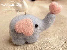 an elephant stuffed animal with pink ears and tusks