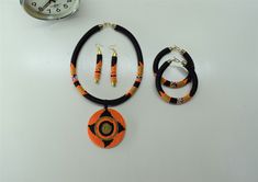 Unique African Maasai Handcrafted Beaded Necklace with an Elegant Look and Brilliant Finish. **GET FREE SHIPPING FOR ADDITIONAL ITEMS PURCHASED. Size(Around the Neck)-16 Inches. Color-Orange, Black, and Gold. Get a pair of Matching Earrings and 2 Bracelets for an extra $7. Yes, Buy Multiple Items and pay shipping for 1 item only- The rest ships Free. (No Limits on the number of Multiple items). With a faster delivery time of 3 days via DHLExpress, Worldwide. Ordinary/Standard Shipping also avail Traditional Orange Jewelry With Black Beads, Traditional Orange Beads For Gifts, Traditional Orange Beaded Necklace As Gift, Traditional Orange Beaded Necklace For Gifts, Orange Necklace With Black Beads For Gift, Orange Necklace With Black Round Beads, Gift Necklace With Orange And Black Beads, Unique Statement Necklace, Woman Necklace