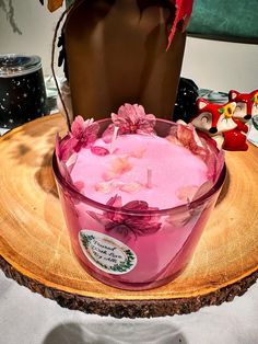 a pink candle sitting on top of a wooden table